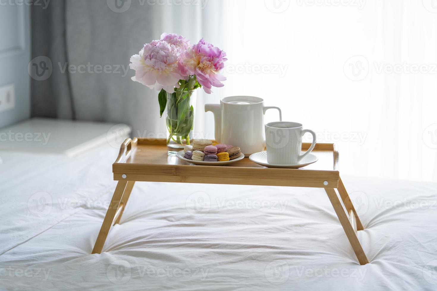 Tray with breakfast on bed. photo