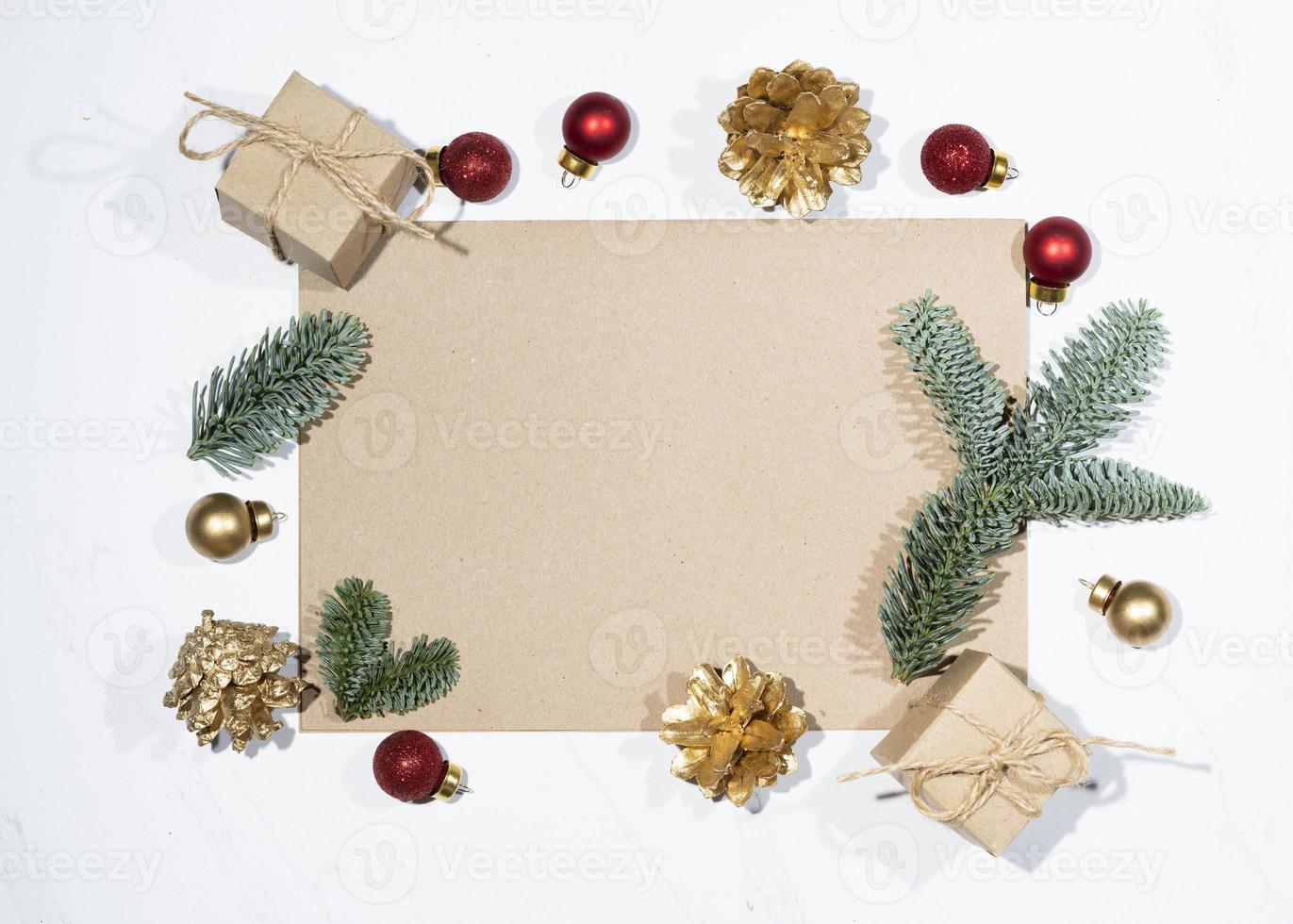 Mockup for a letter or a Christmas invitation with gold fir cone photo