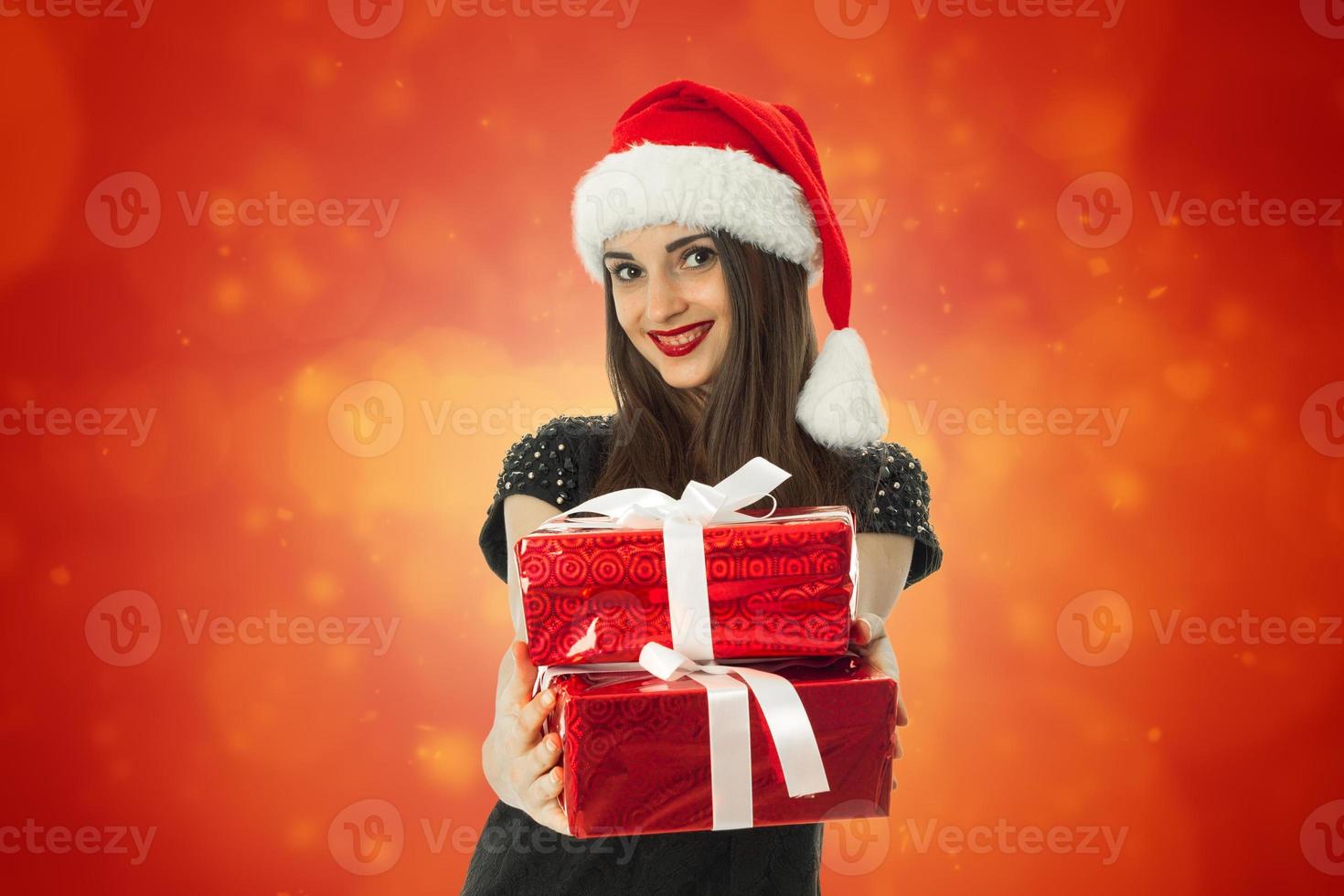 Adorable Woman in santa hat with red gift photo