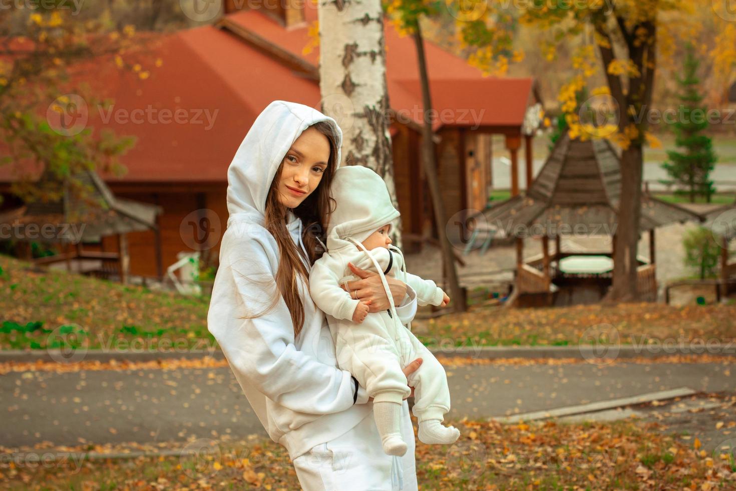 beautiful young mom with baby in autumn photo