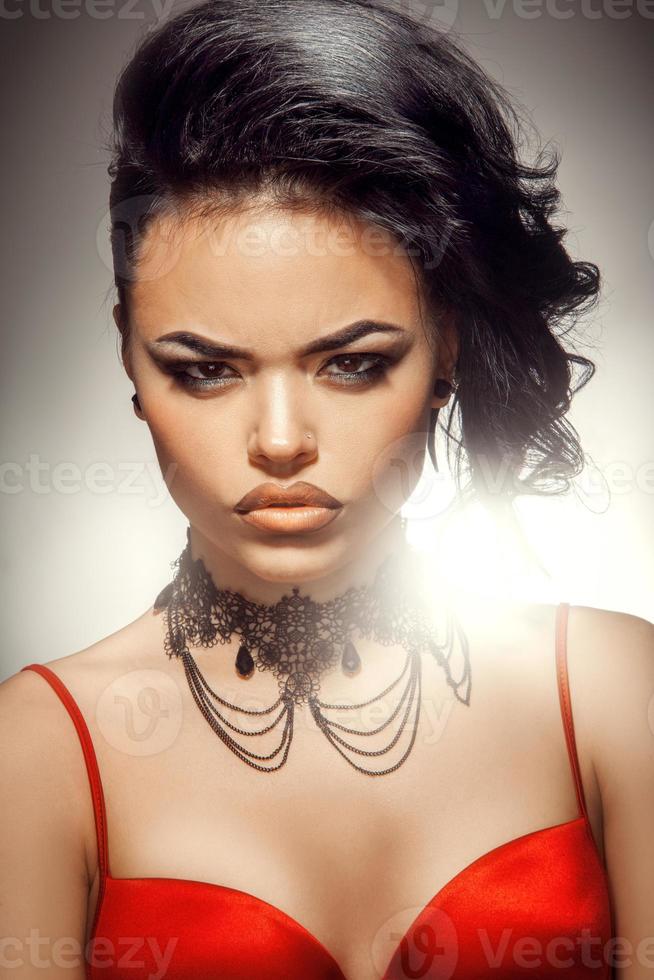 Nice young woman with red bra and professional make up in studio photo