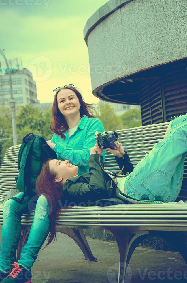 tourists resting on a bench photo