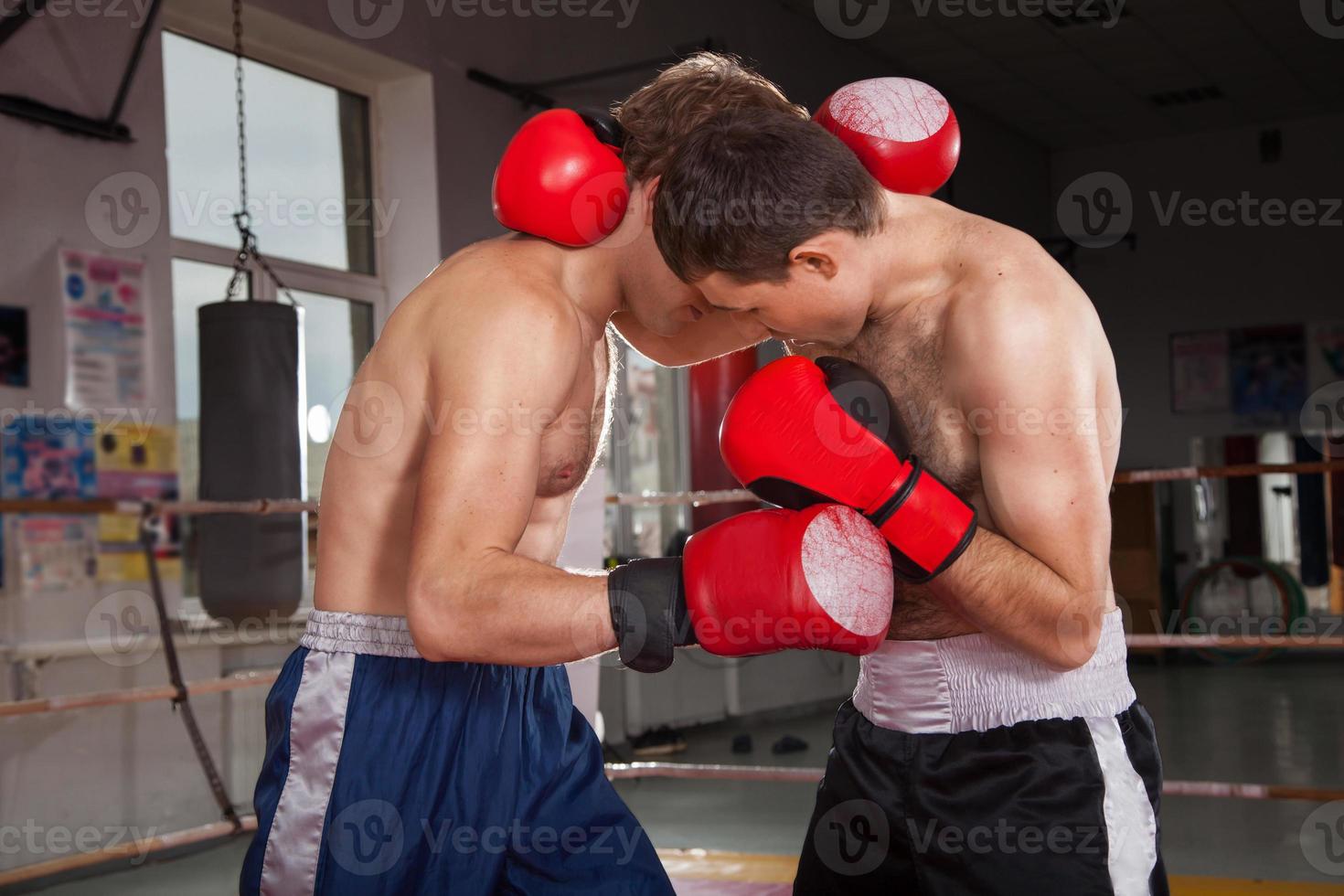 Two men is boxing on the ring photo