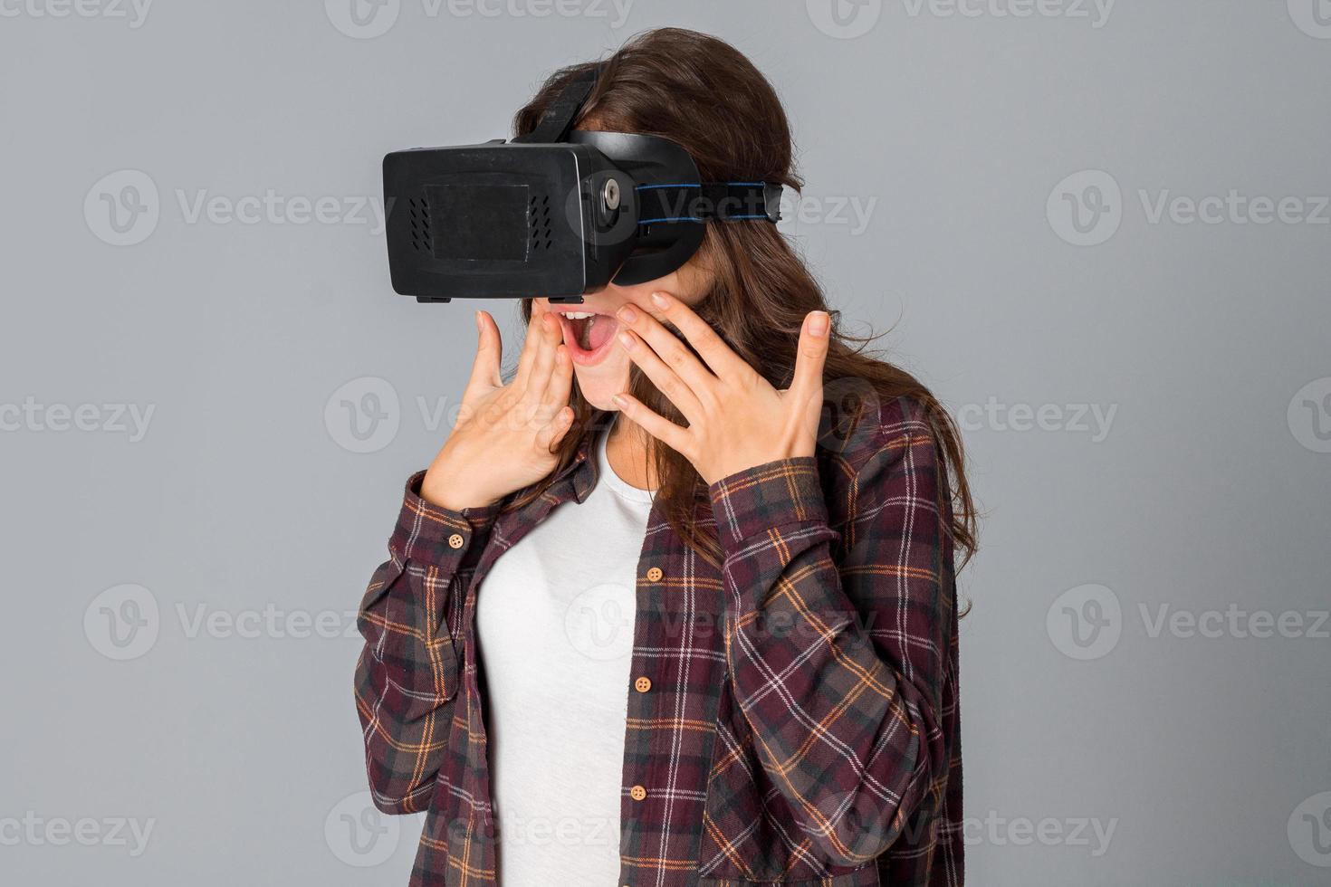 cheerful woman in virtual reality helmet photo