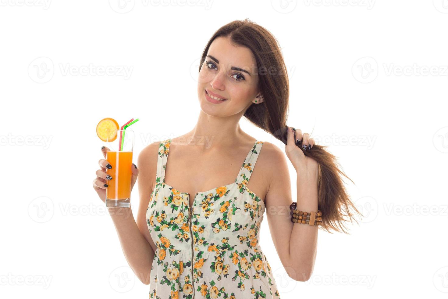 beautiful young girl with long hair and a Sarafan holds in her hand a glass of juice isolated on white background photo