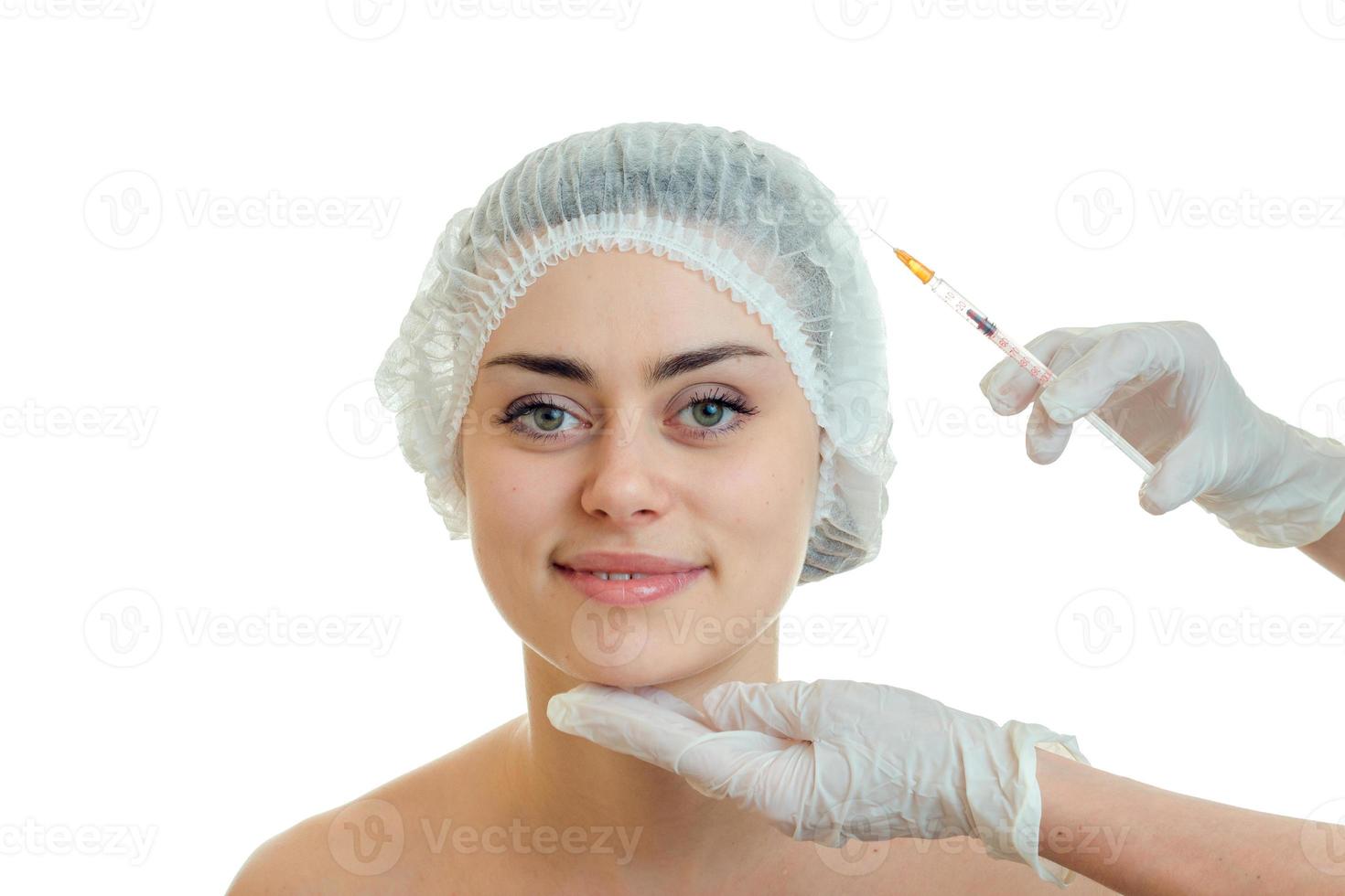 cheerful girl by the plastic surgeon does prick photo