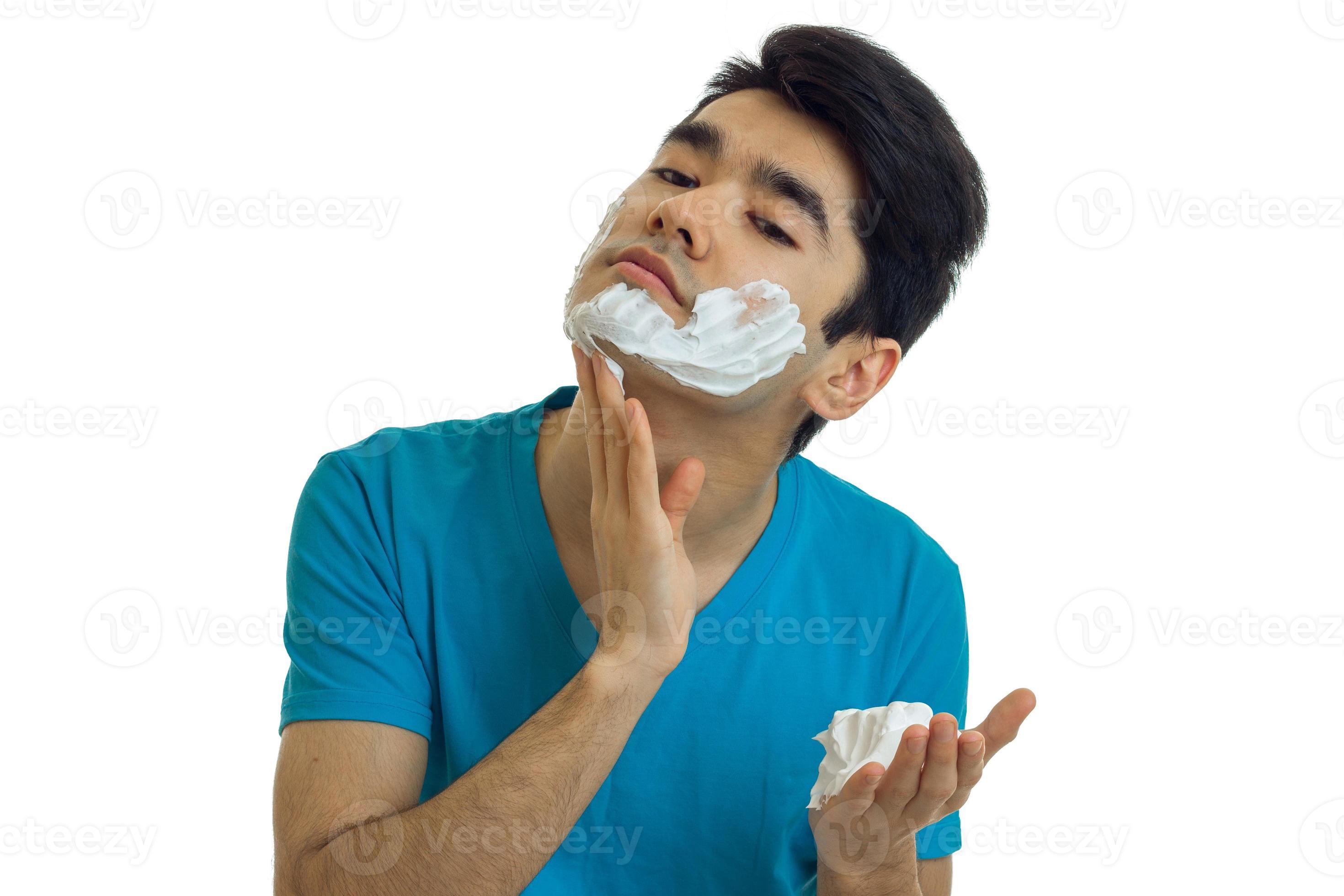 wonderful young guy with black hair tilted head and shaving foam on