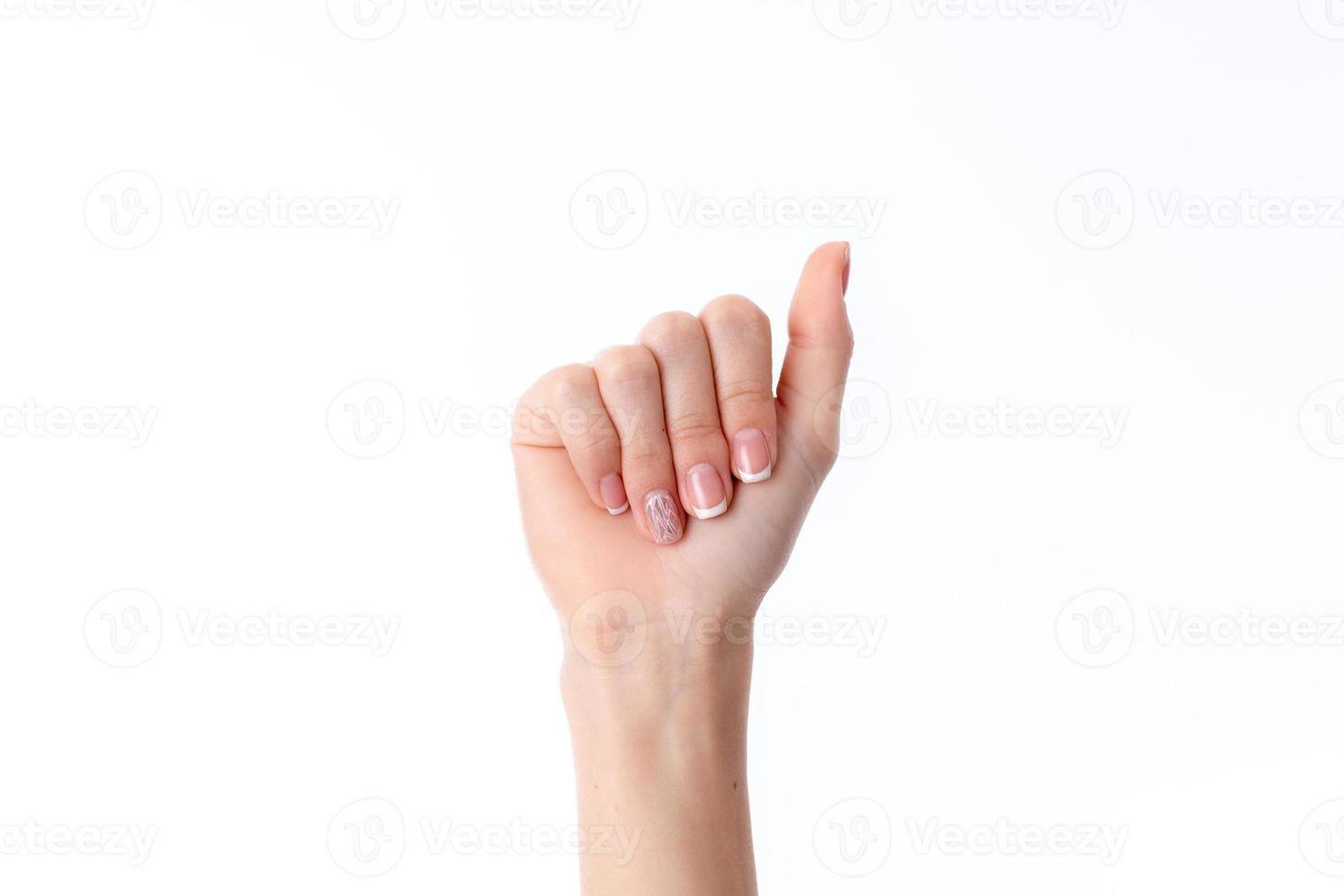female hand extended straight down with bent fingers isolated on white background photo