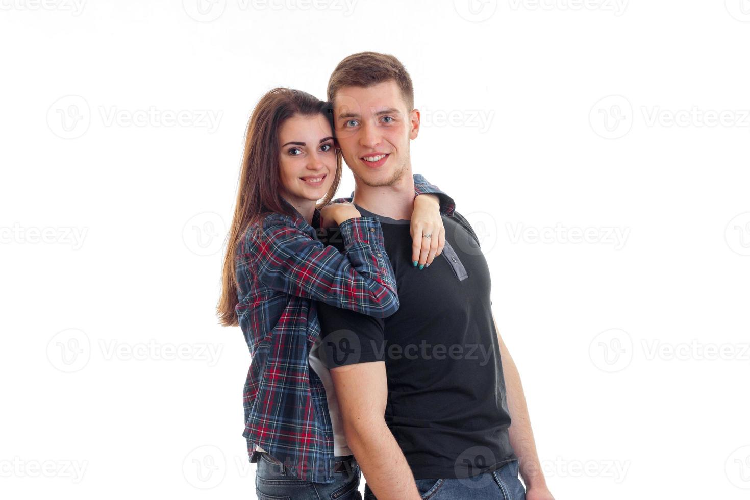 charming couple standing near staring and smiling and hugging the girl the guy photo