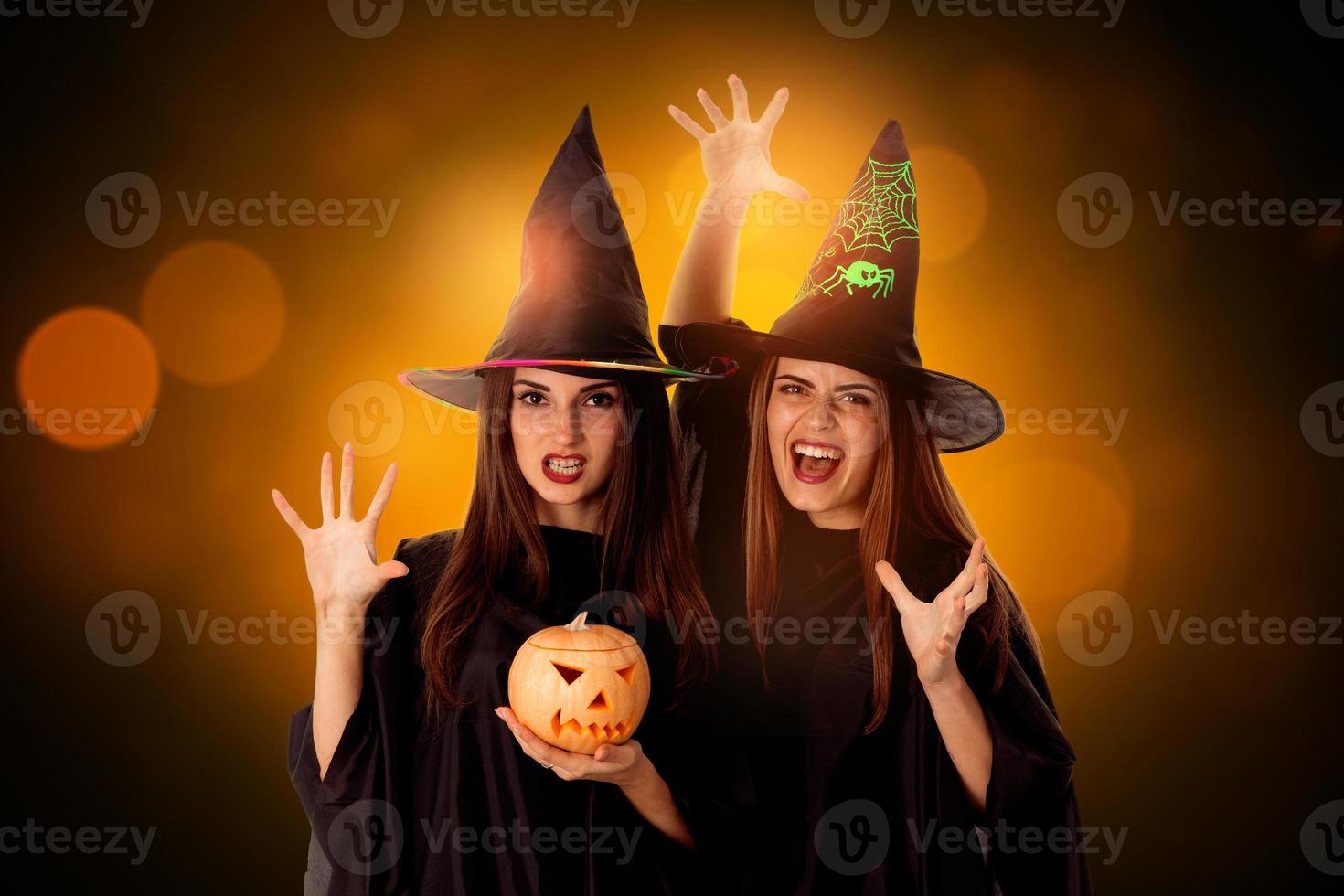 young women with pumpkins in hands photo