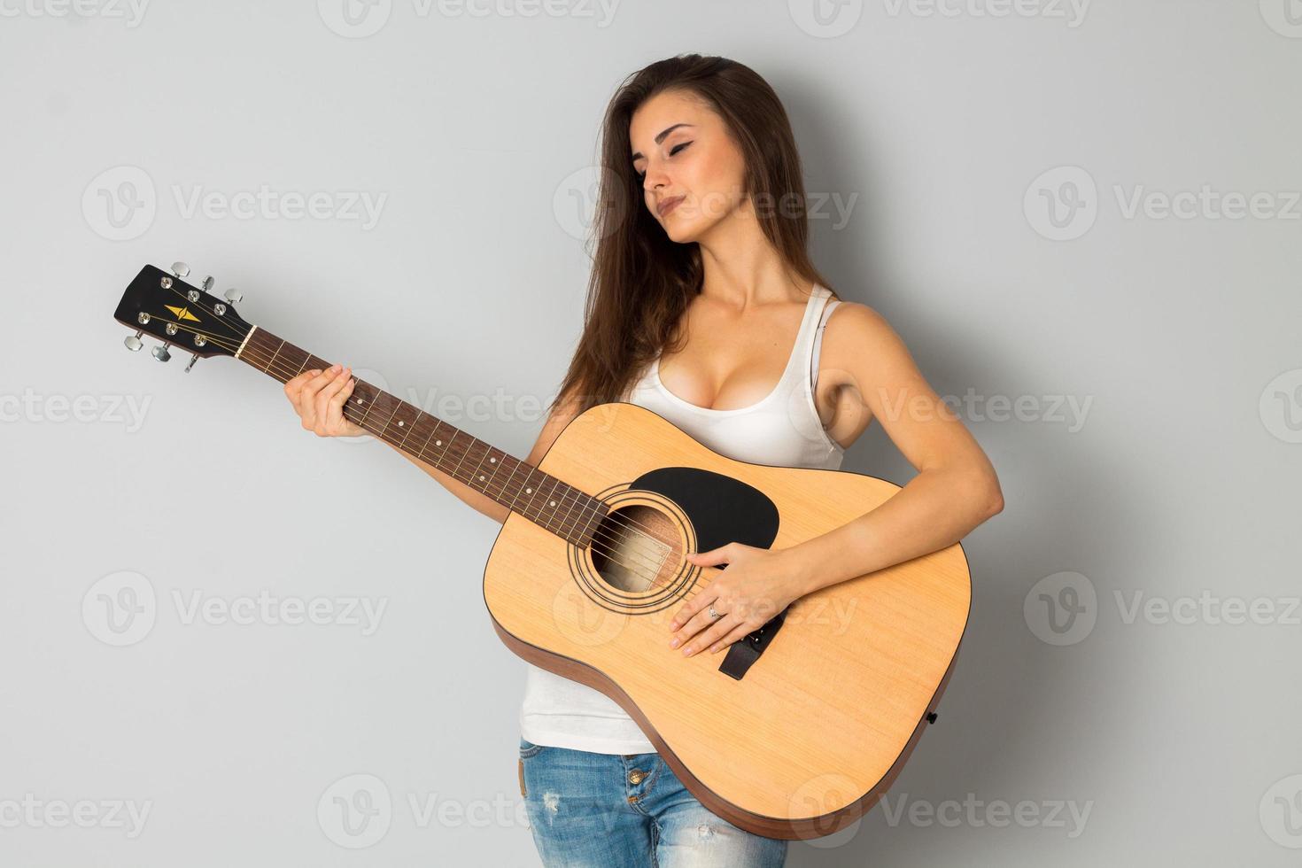 young brunette woman with guitar photo