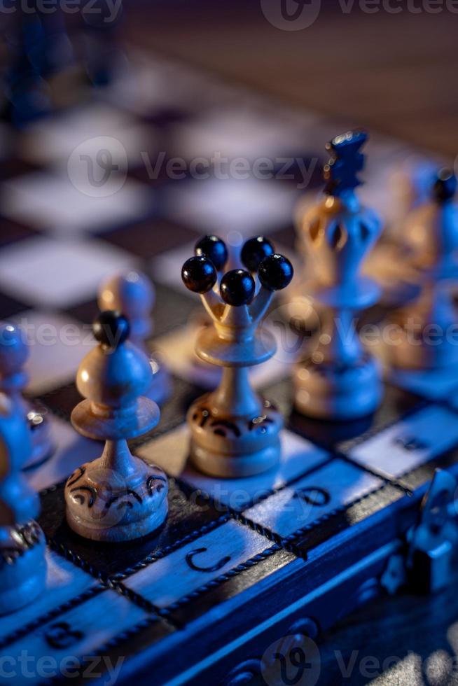 Chess board with chess pieces on blue background. Concept of business ideas and competition and strategy ideas. White king and queen close up. photo