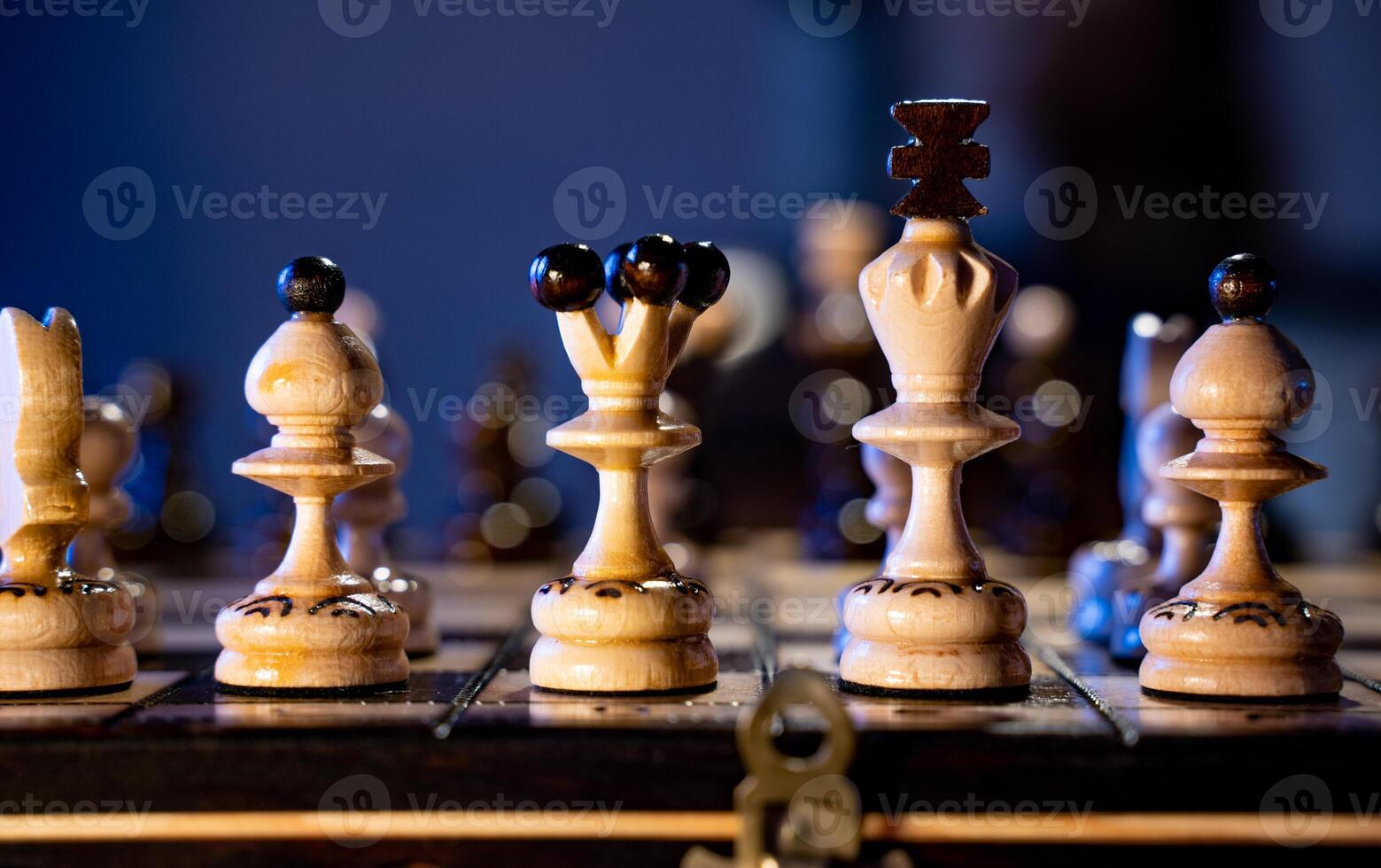 Chess board with chess pieces on blue background. Concept of business ideas and competition and strategy ideas. White king and queen close up. photo