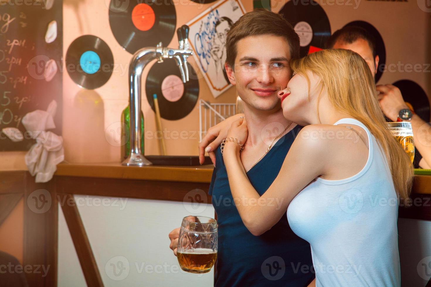 Girlfriend hug her boy in bar photo