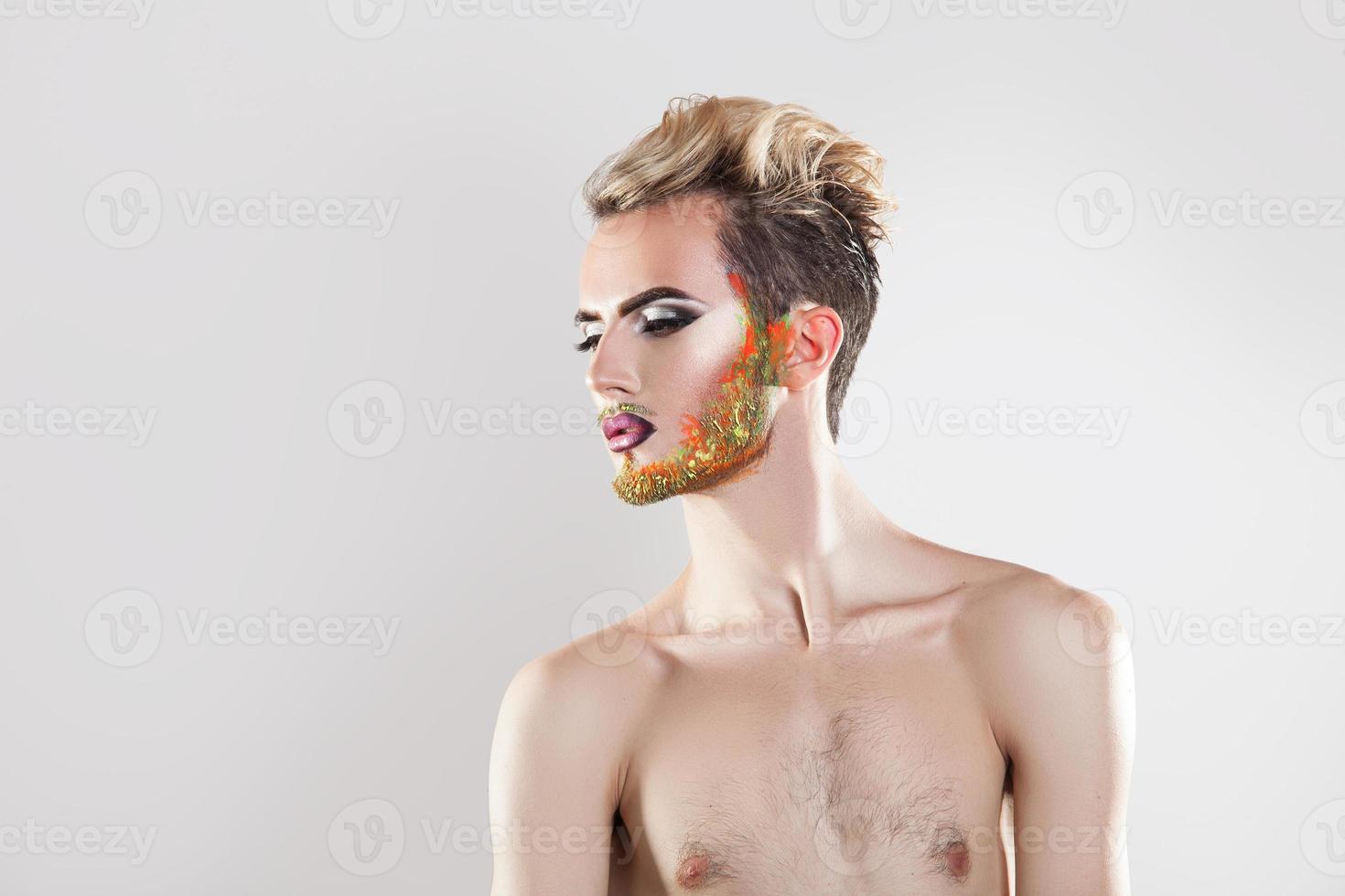 Horizontal picture of beauty man with makeup and multicolor beard photo