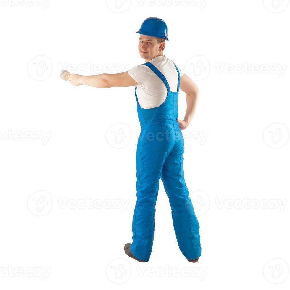 builder in blue uniform with a brush in hand photo