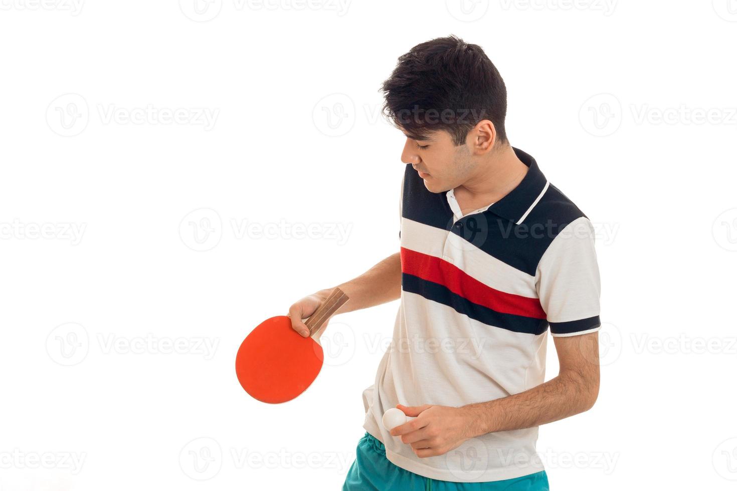 young guy holding tennis rackets and lowered his head photo