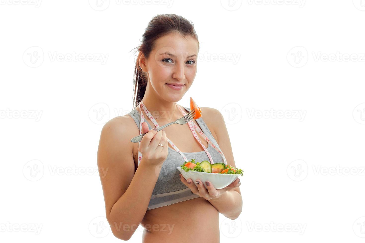 close-up portrait of a young girl with a plate of lettuce in the hands photo