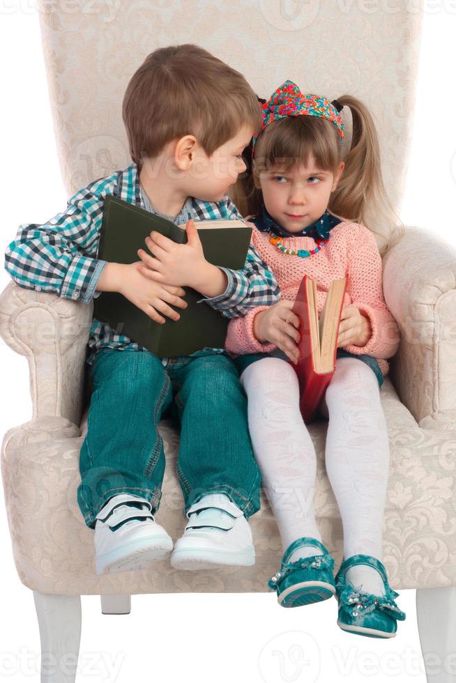 Children sit in a chair with books photo