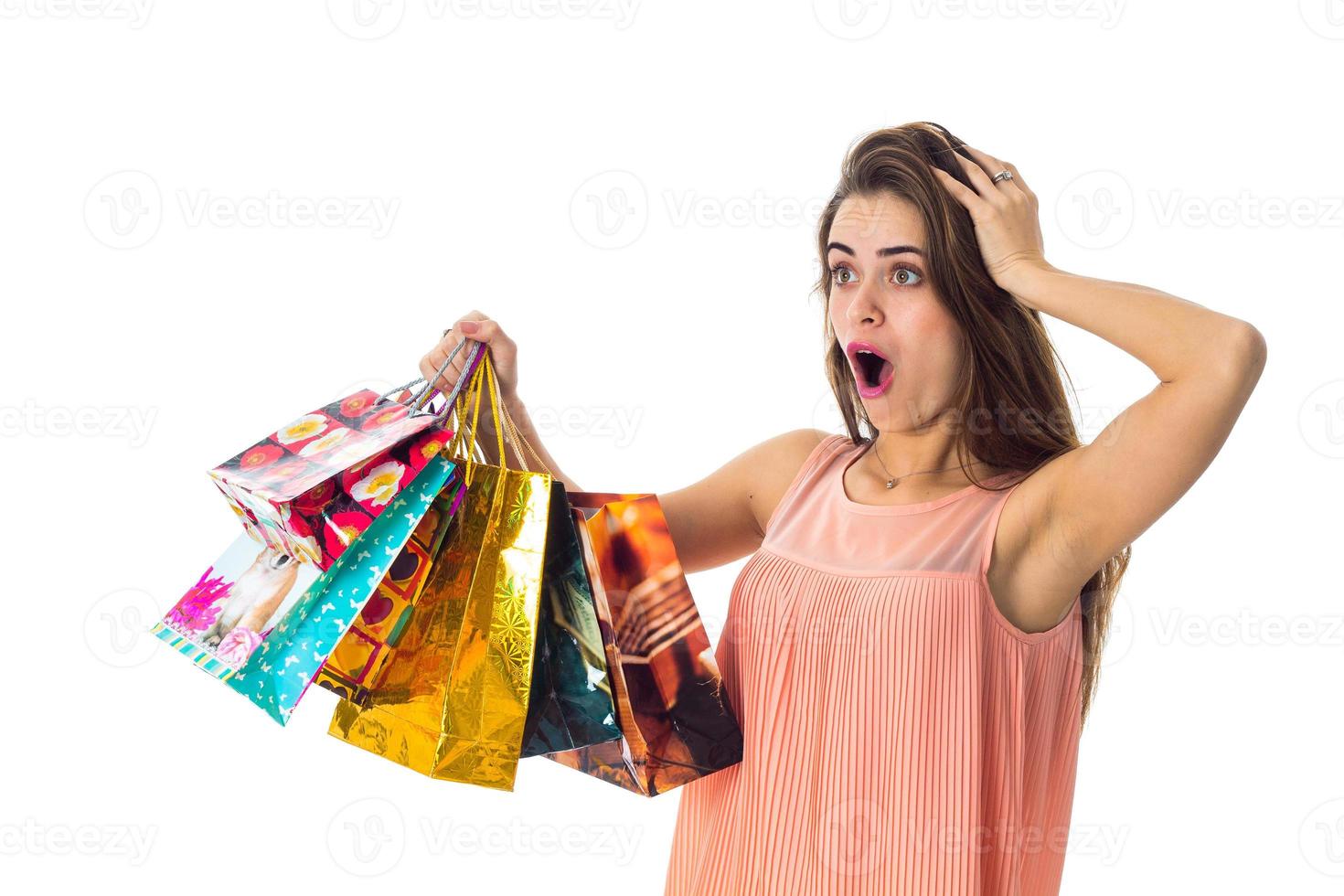 girl raised with surprise packets to itself and keeps hand hair isolated on white background photo