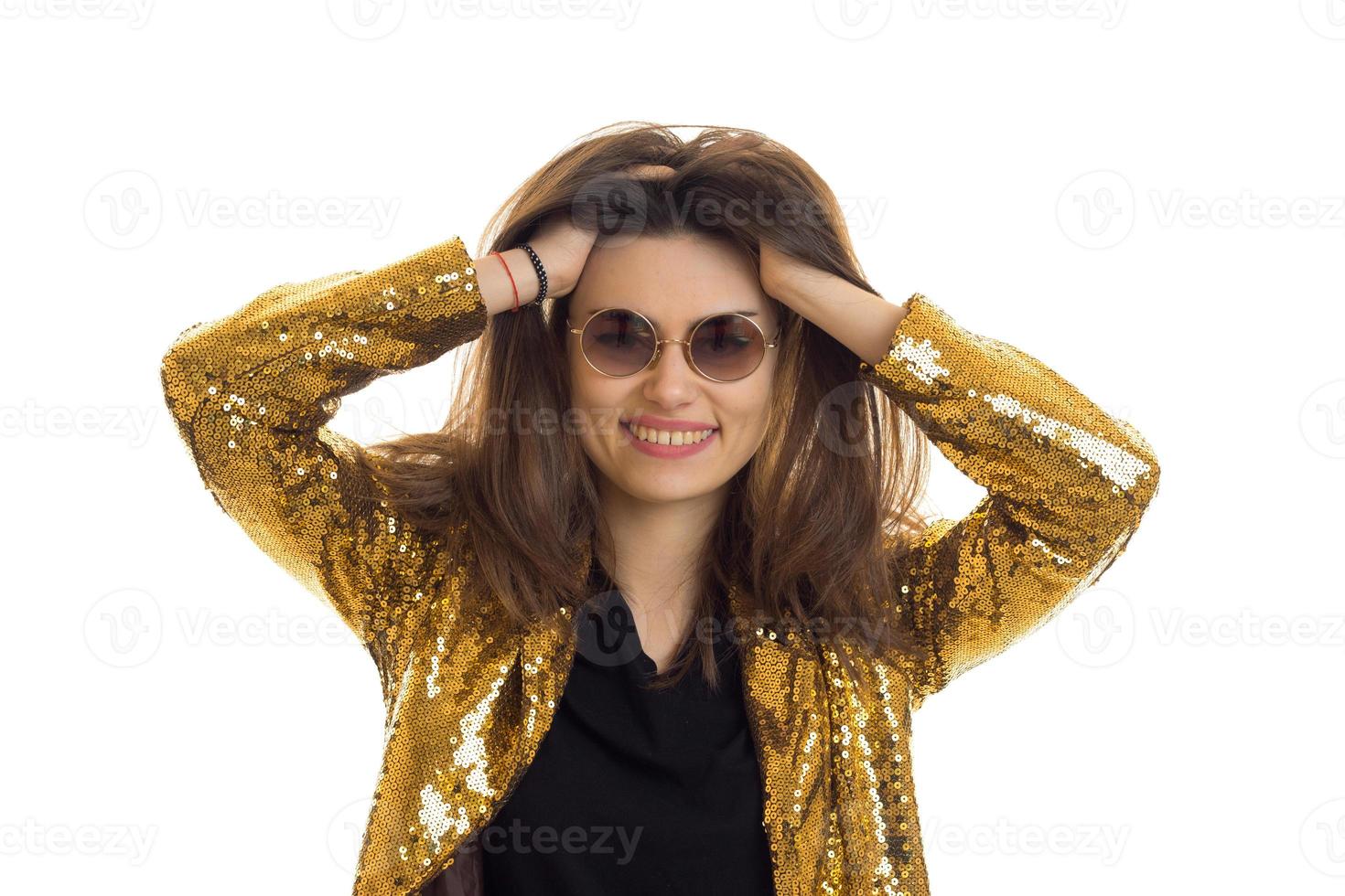 Funny girl in round sunglasses wears golden jacket and smiles photo