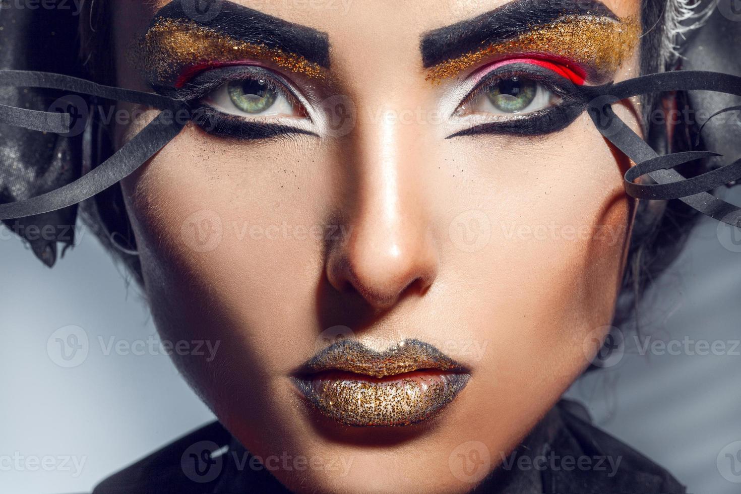 Close up portrait of charming adult woman with gold lips photo