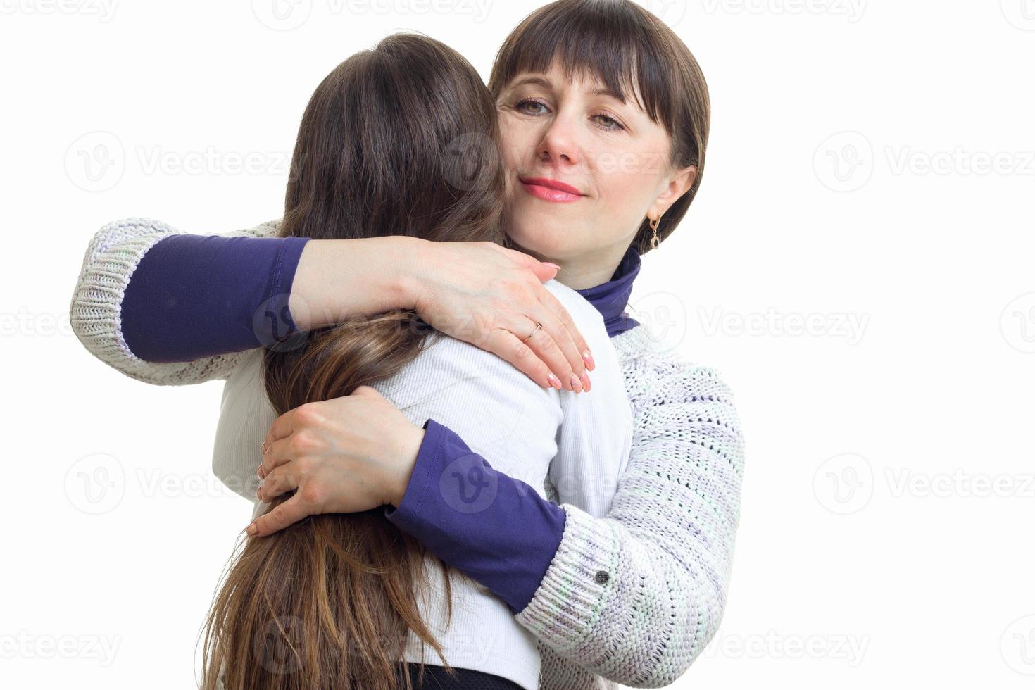 mom tightly embraces her daughter photo