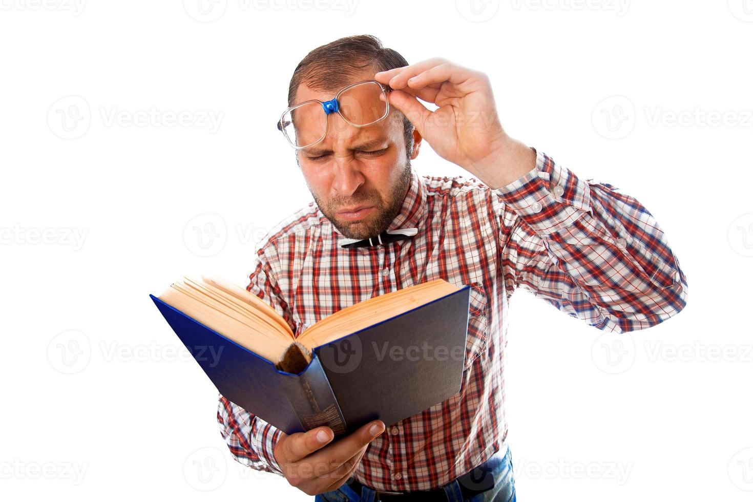 Adult man with poor eyesight try to read a book photo