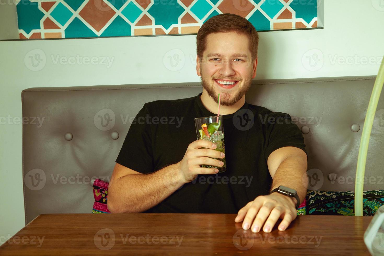 man posing at the cafe and smiling photo