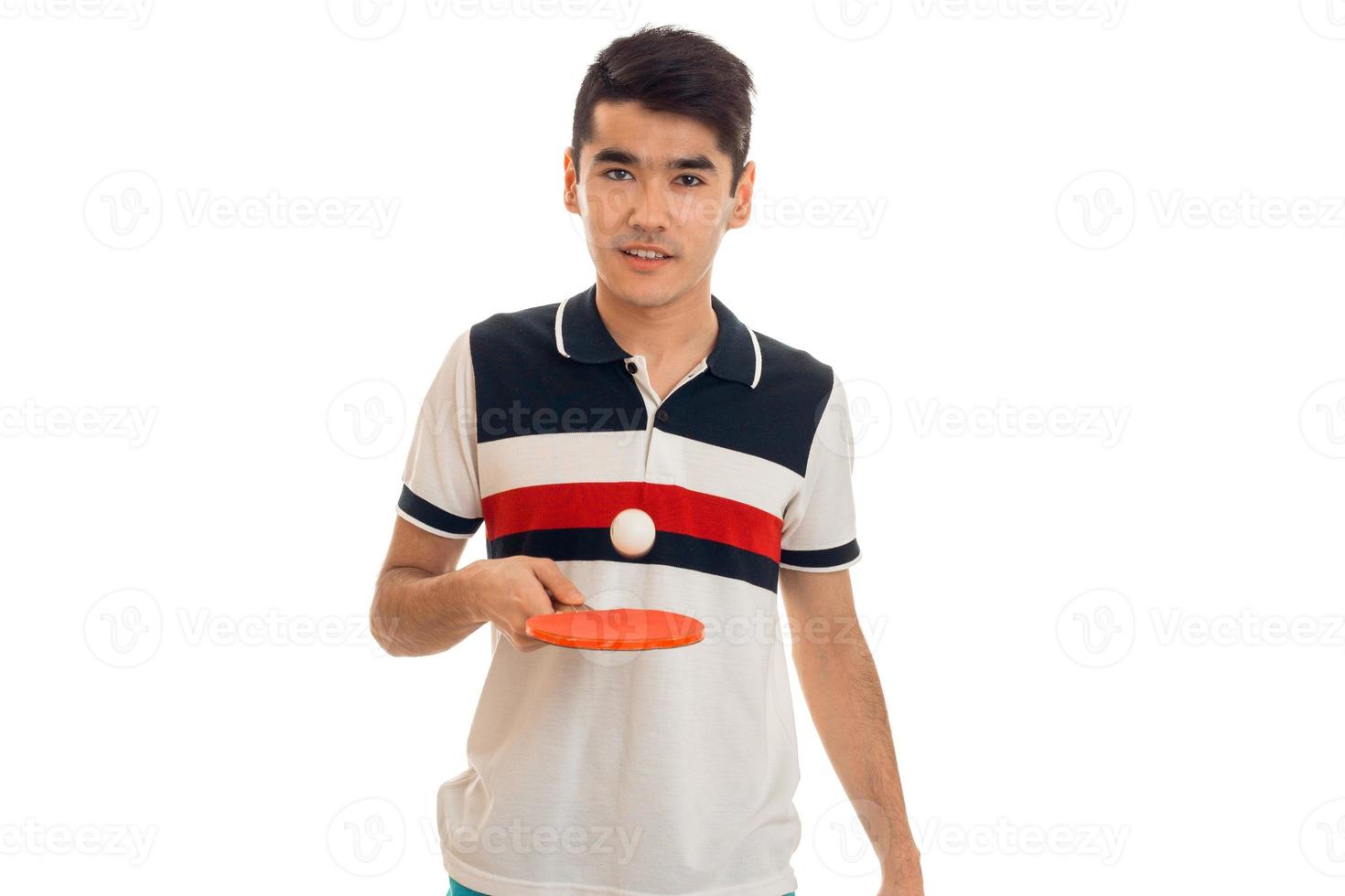 pretty young brunett man playing ping-pong and looking at the camera isolated on white background photo