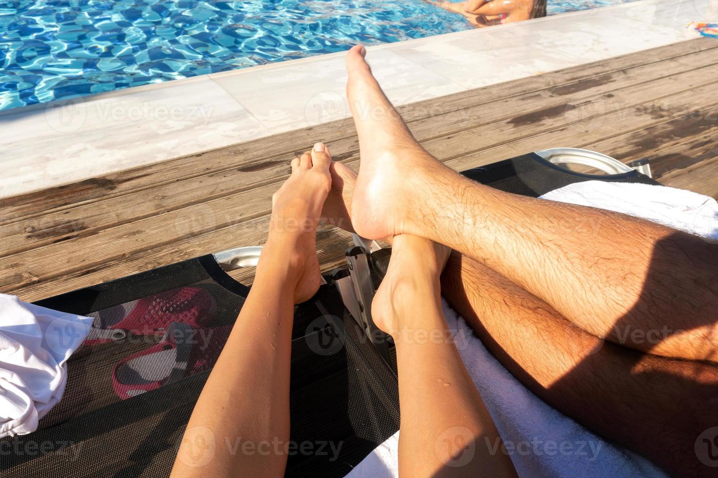 feet of couples on the beach photo