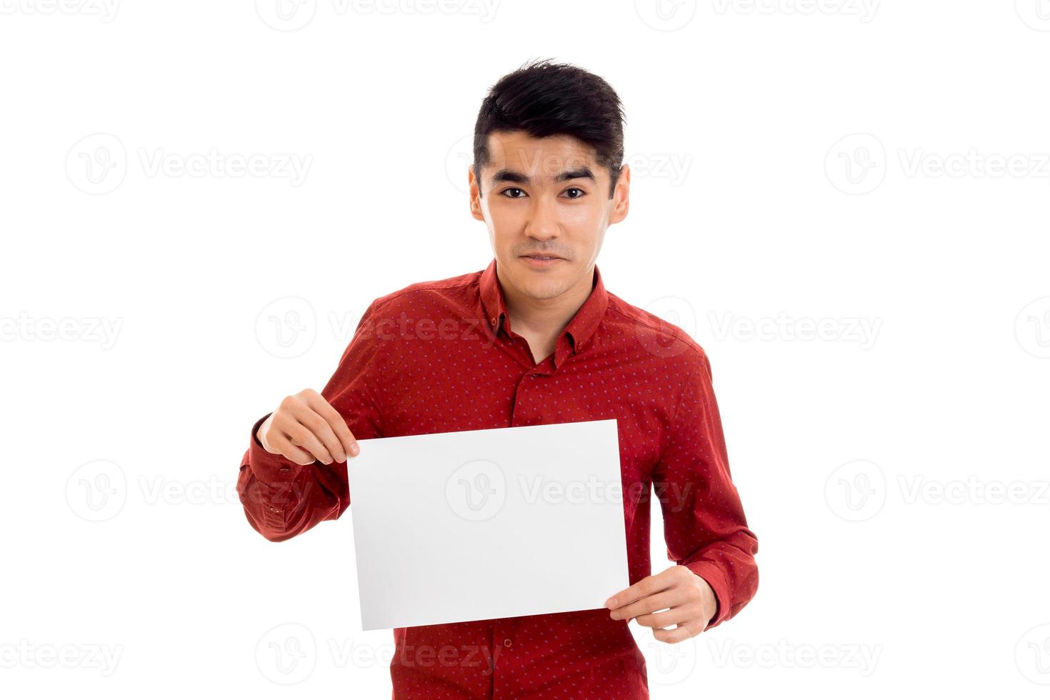 young pretty male model in red shirt with empty placard in hands isolated on white background photo