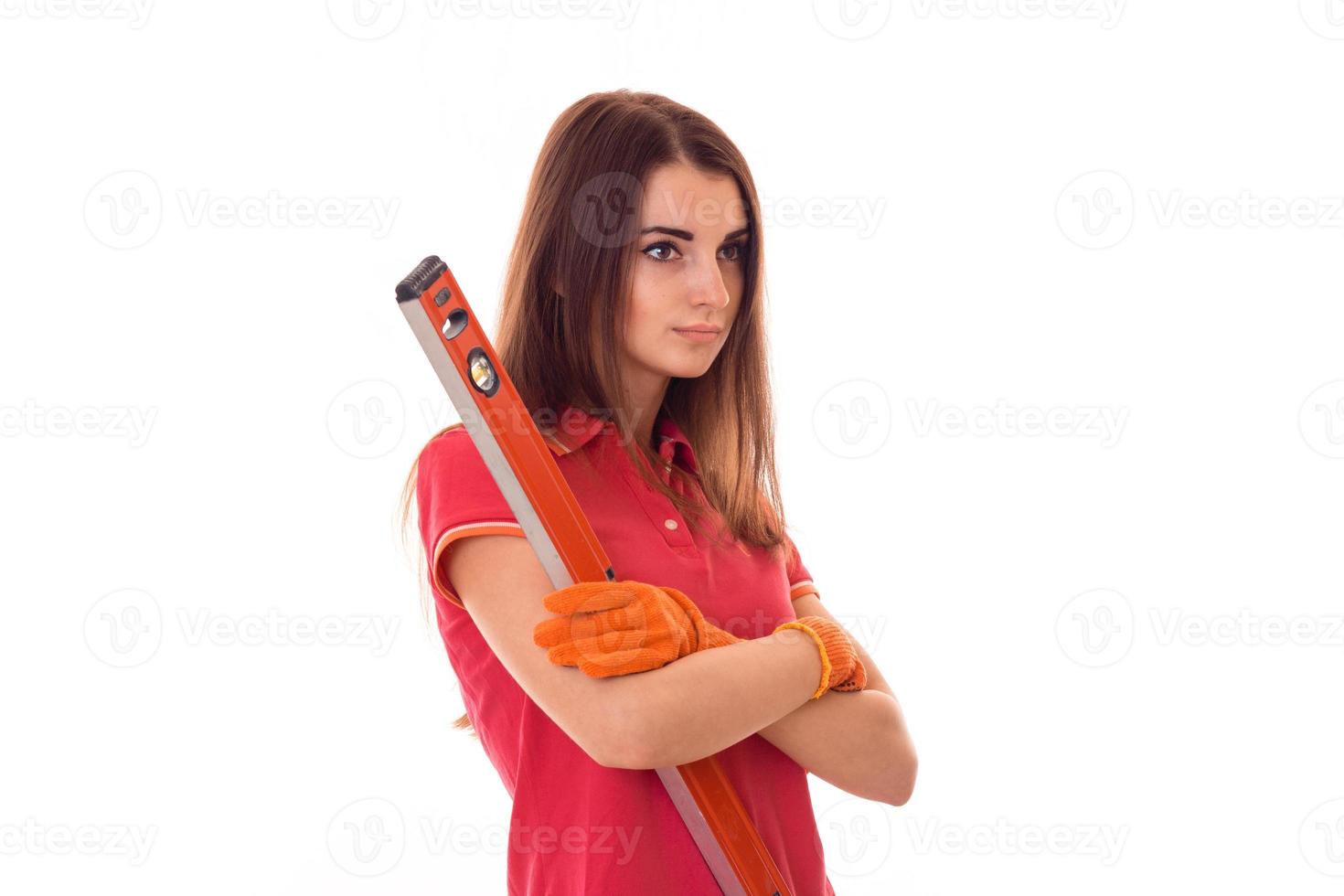 young beautiful girl holding a tool for repair and looks toward photo