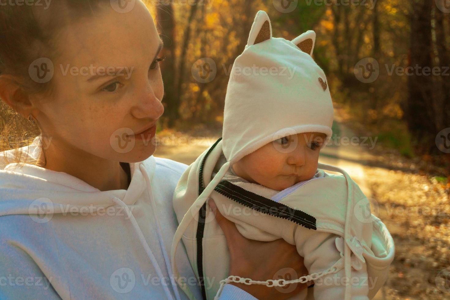 beautiful young mom with baby in autumn photo