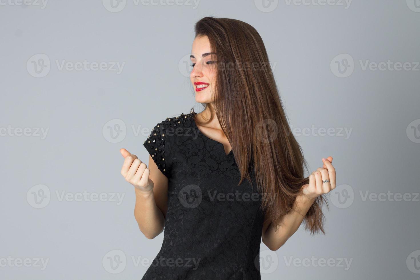 girl in black dress posing in studio photo