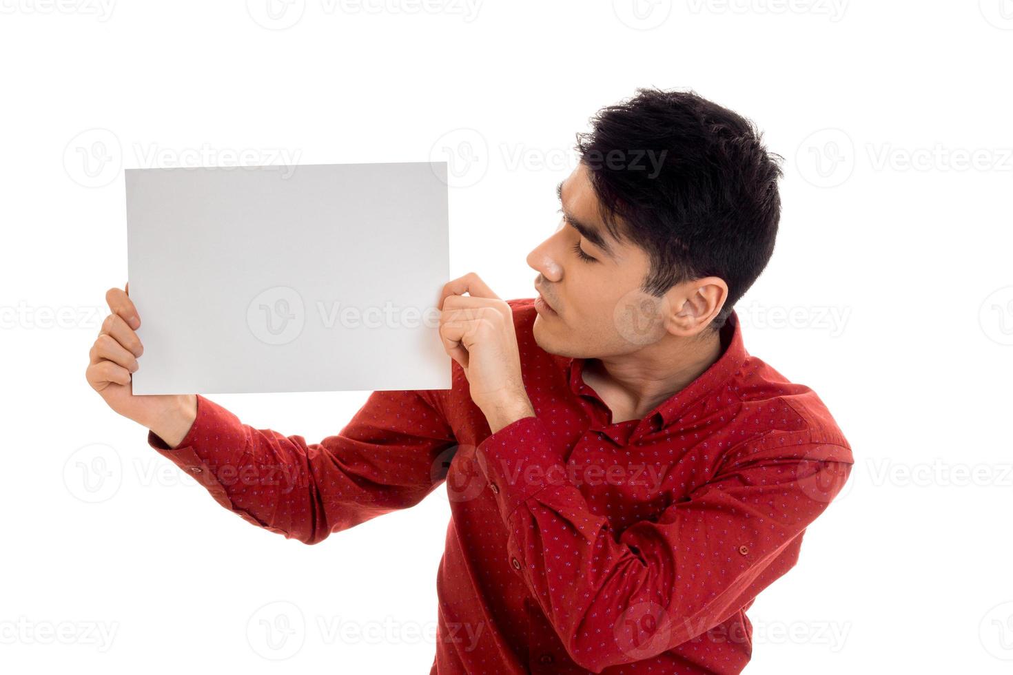 Young handsome male model posing with placard in hands isolated on white background photo