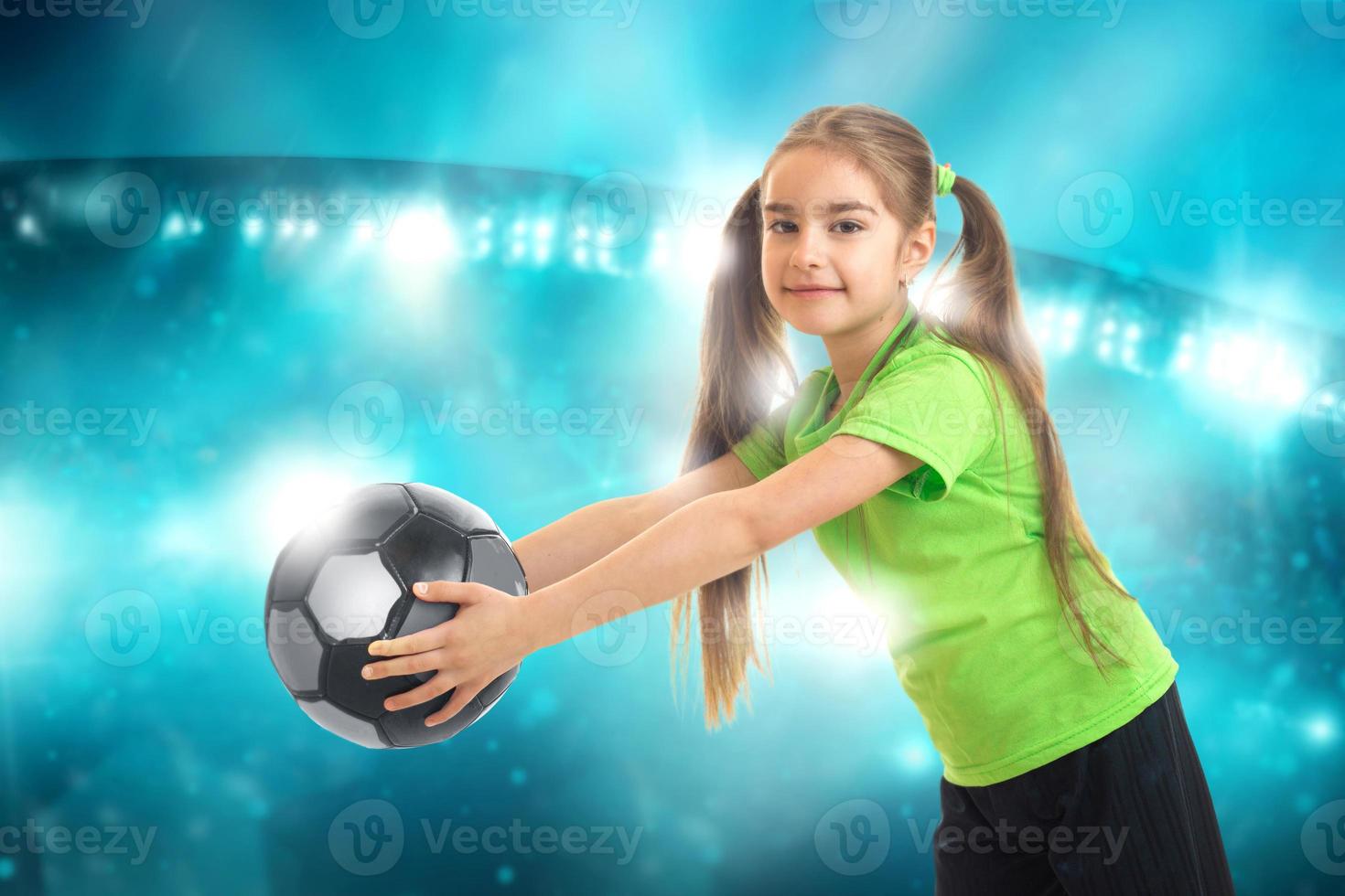 little athletic girl with ball in her hands smiles photo