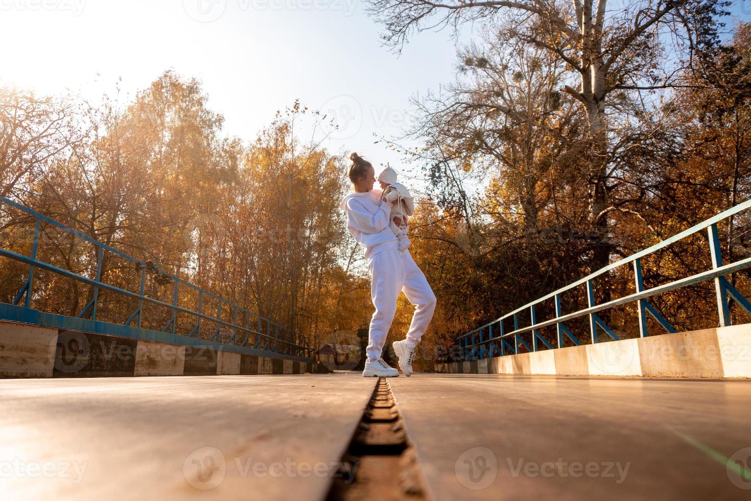 beautiful young mom with baby in autumn photo