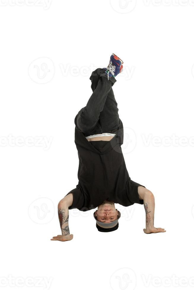 Man in casual clothes standing on his head photo