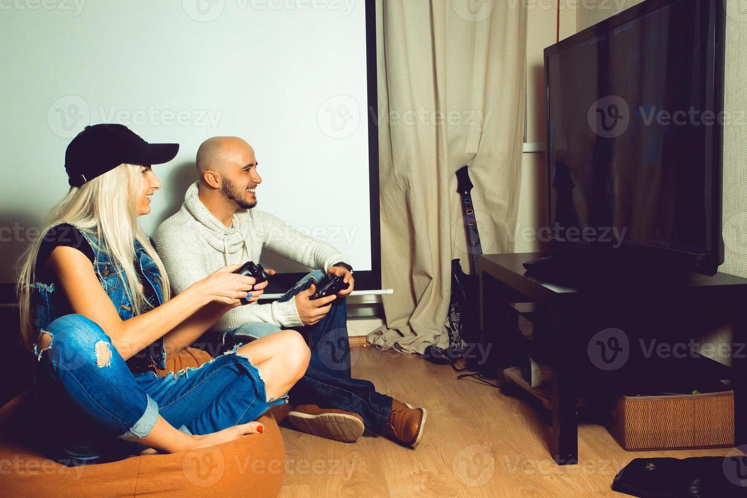 Girl with a guy playing computer games and fun photo