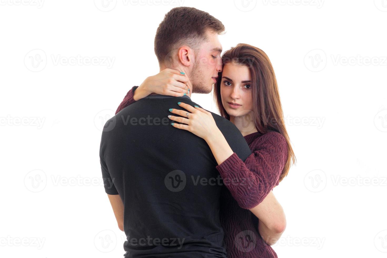 Cute young couple in love hugging in studio photo