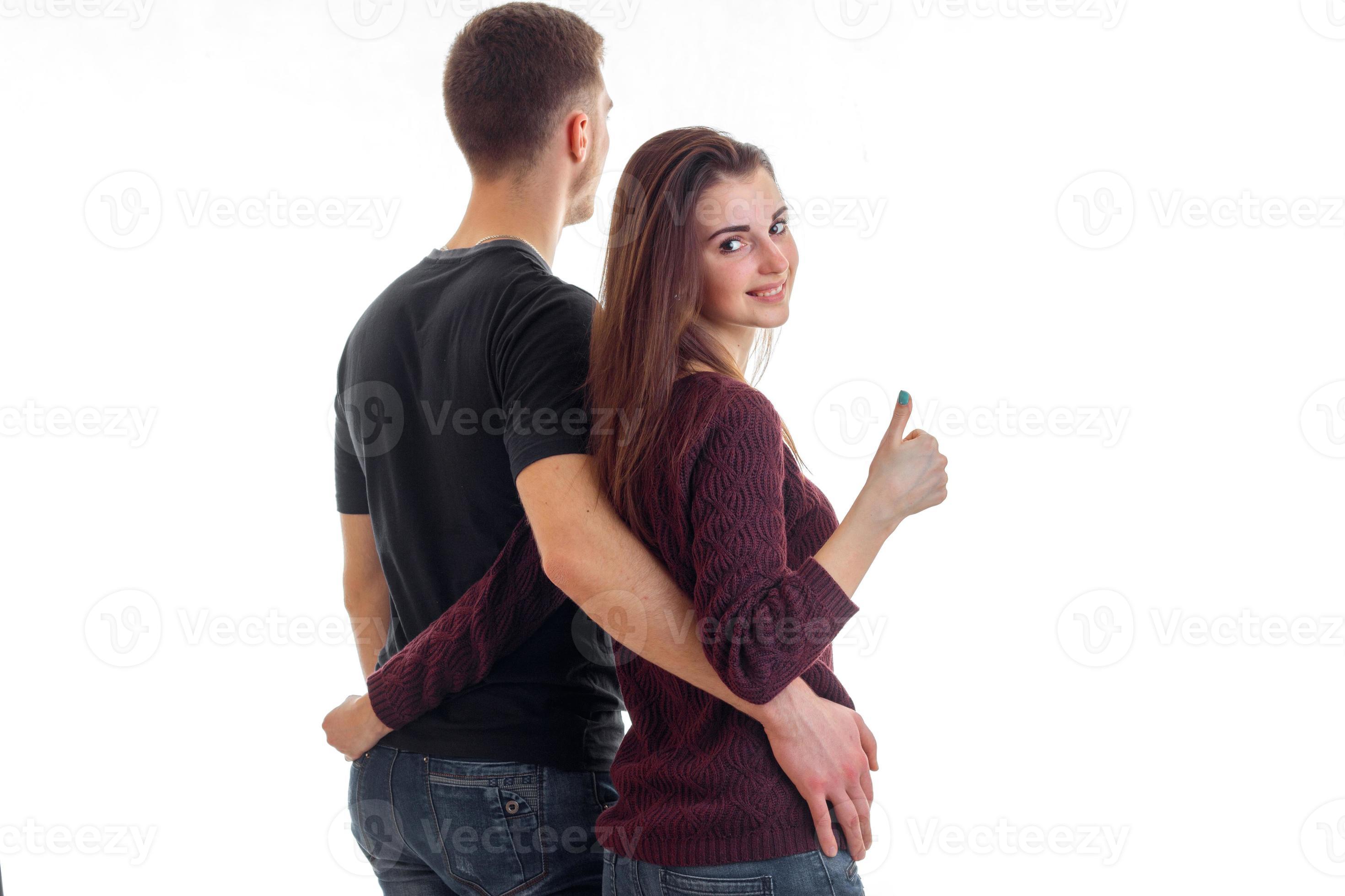 young couple hugging waist and girl showing thumbs up 16097274 Stock Photo  at Vecteezy
