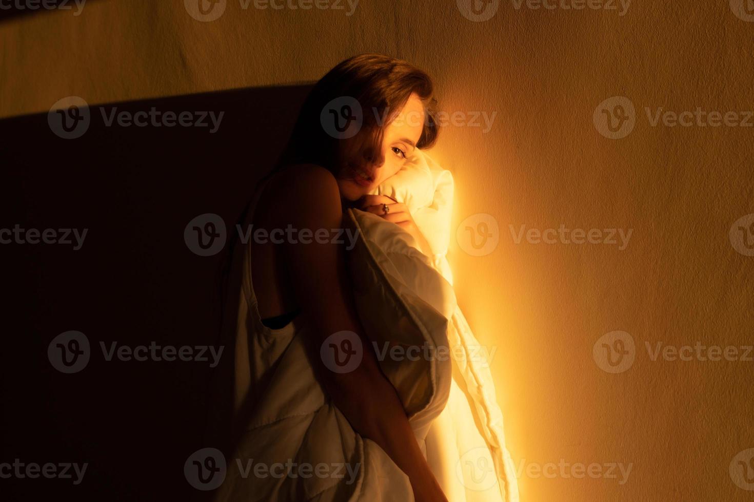 girl in looking into the camera in the warm rays of sunset photo