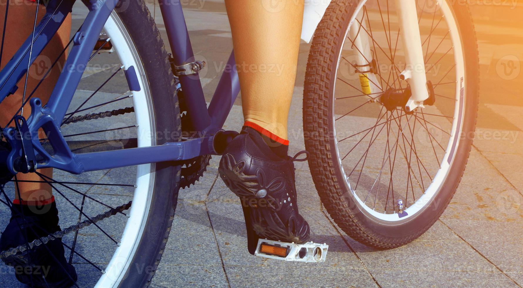 female legs on bicycle outdoors close up photo