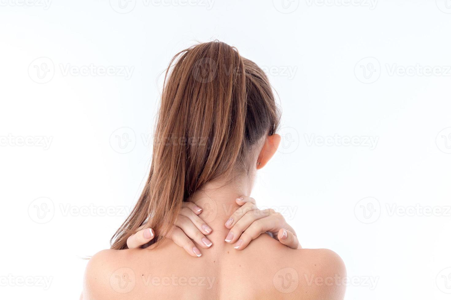 the girl stands back forward and keeps the ball neck is isolated on a white background photo