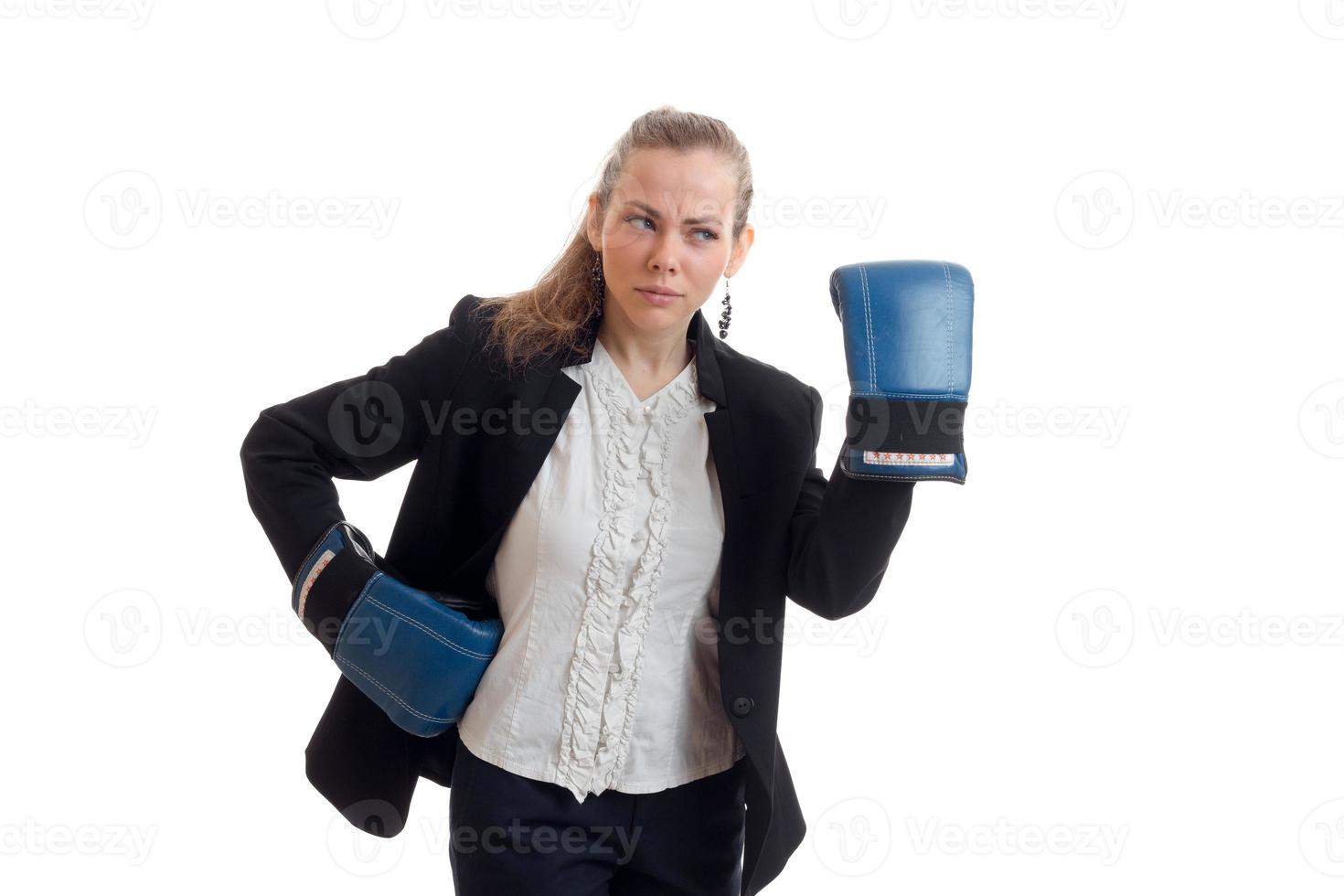 una joven encantadora con camisa y chaqueta mira hacia otro lado y usa guantes de boxeo en las manos foto