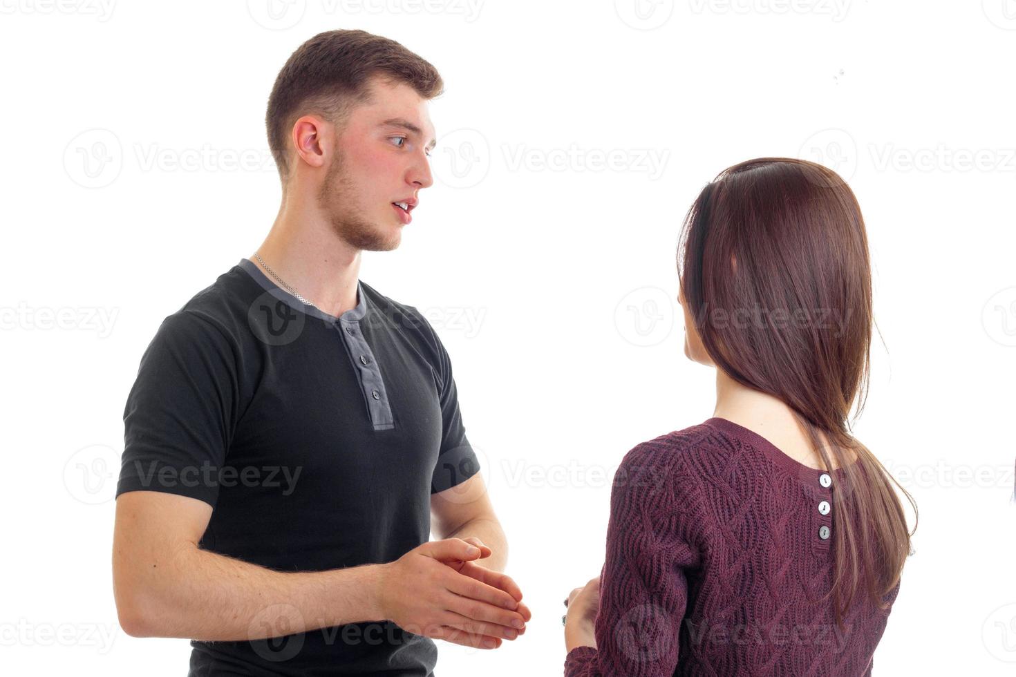 young high guy stands opposite the girls and about something said photo