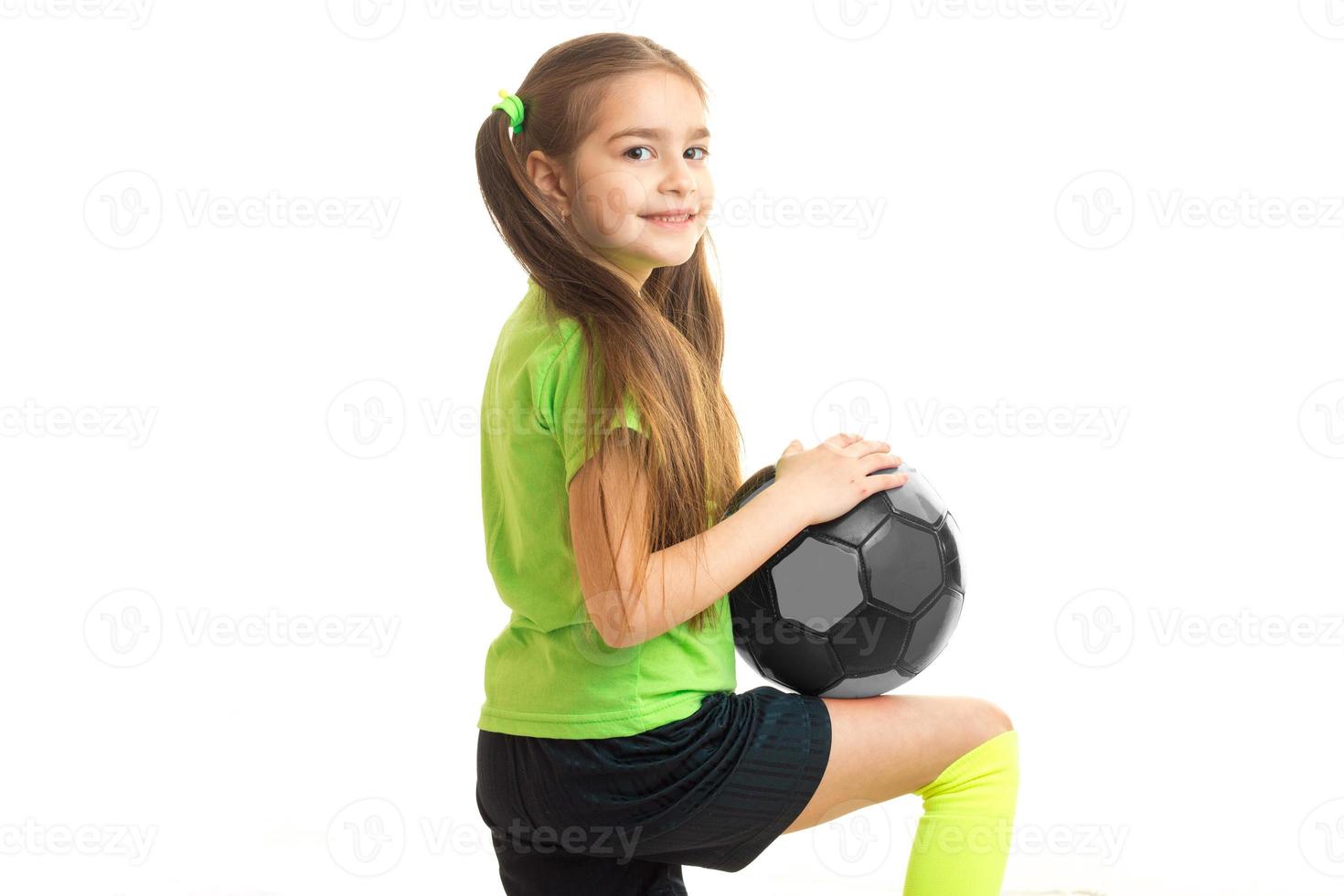 Cutie little girl with ball in studio photo