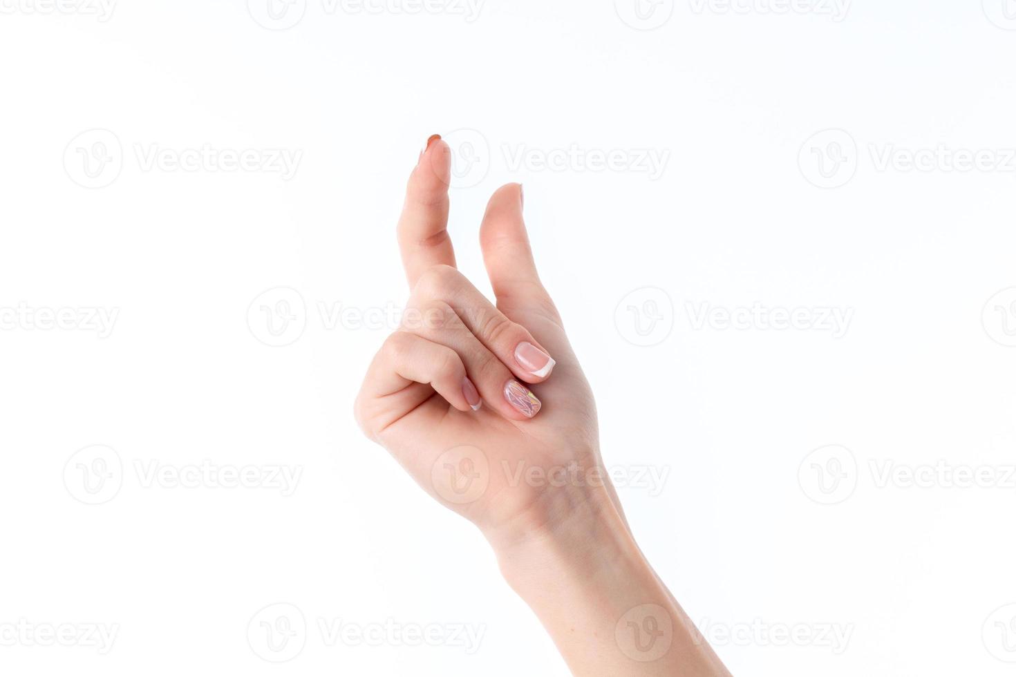 female hand showing the gesture with raised up the index finger and thumb photo