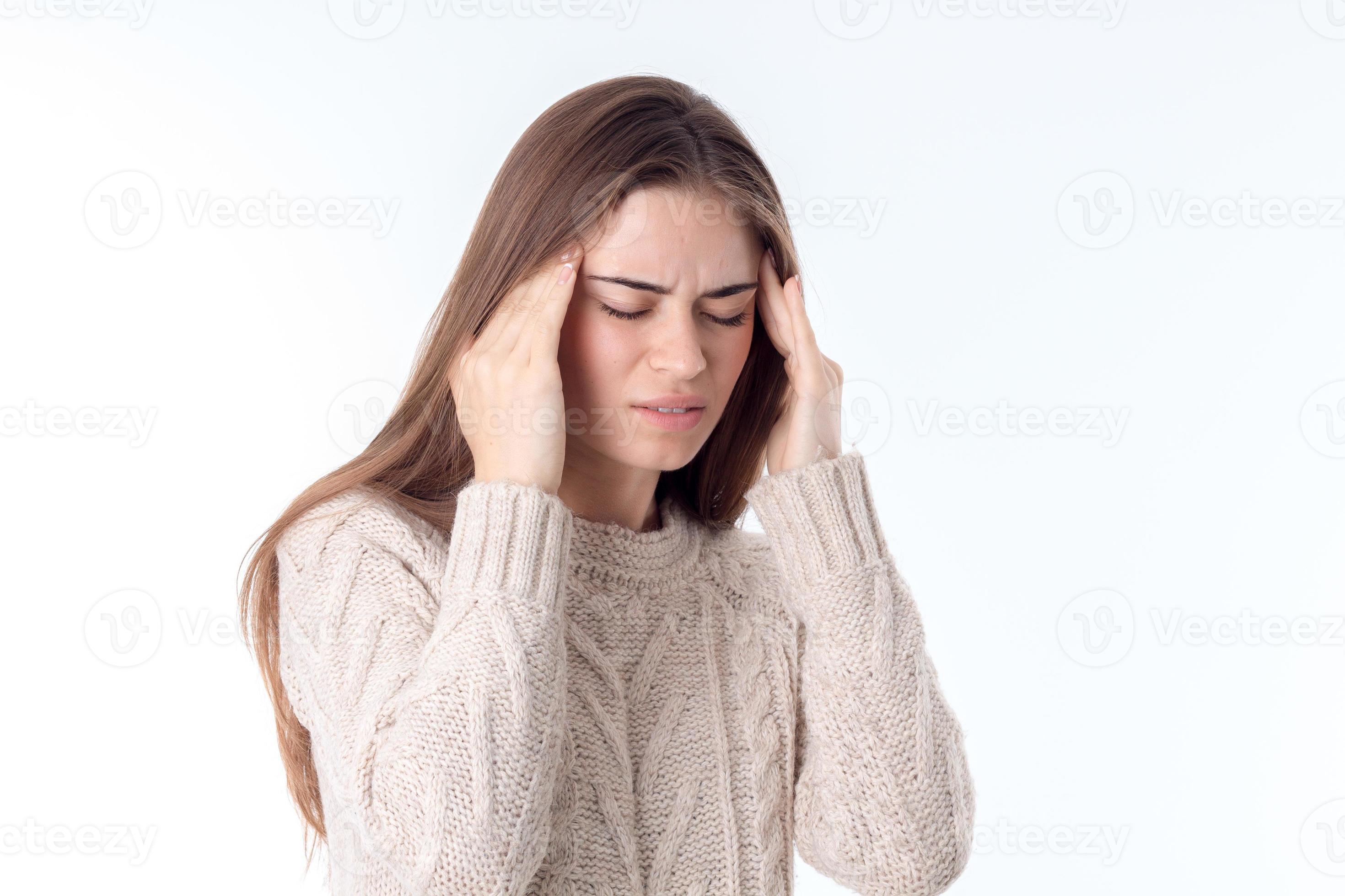 young girl with headache keeps hands whiskey isolated on white
